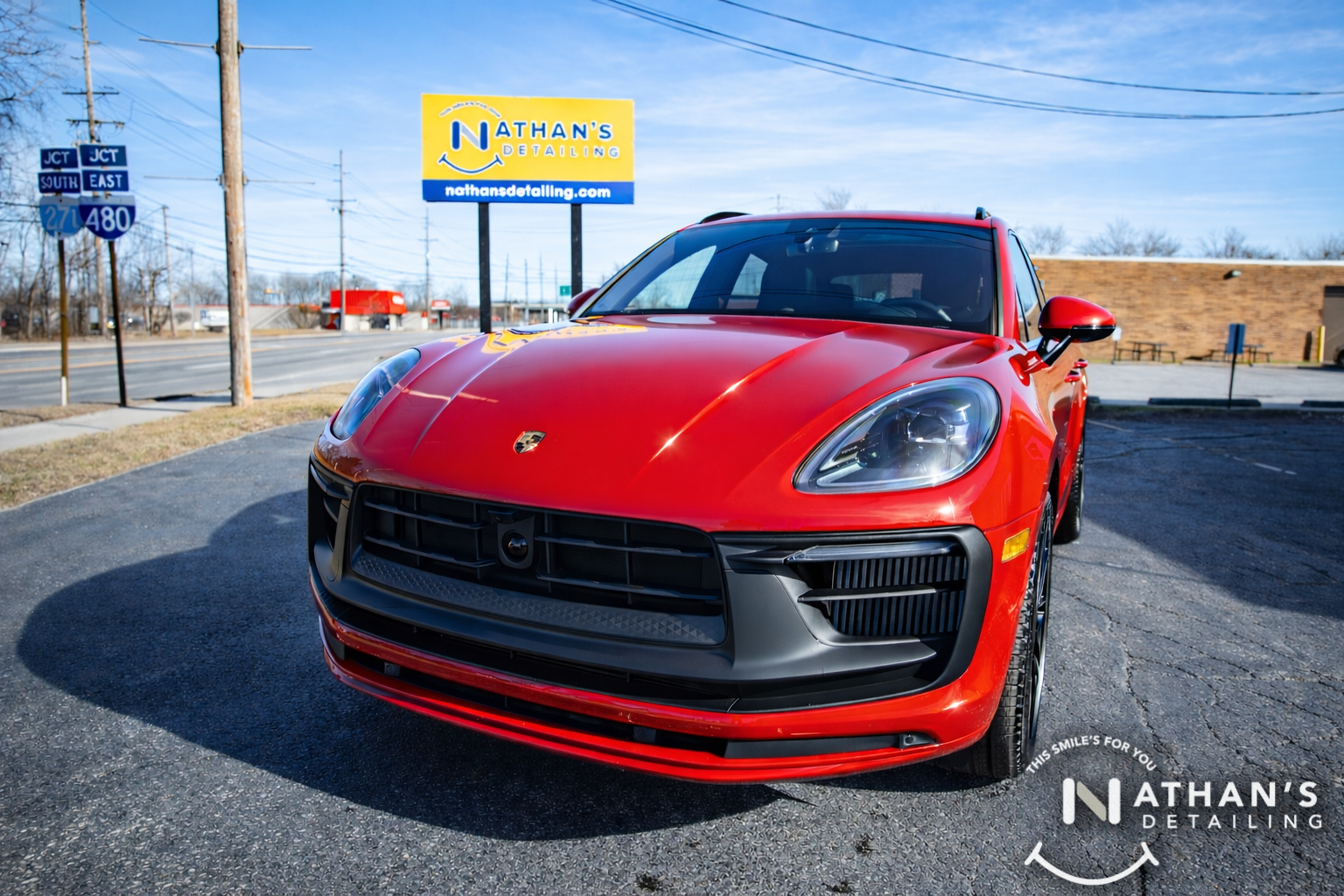 Red Porsche SUV with a glossy finish after ceramic coating.