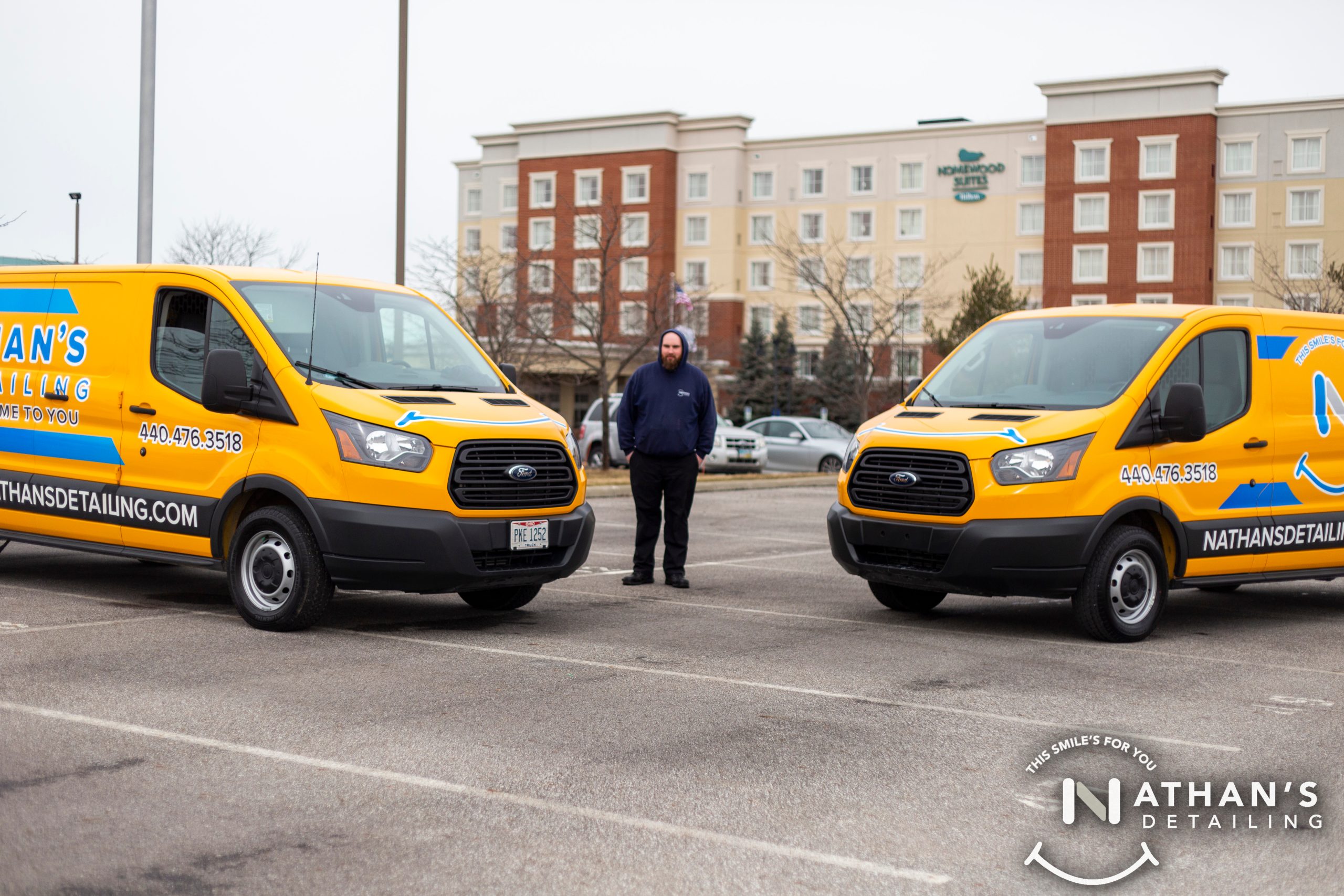 Two Nathan’s Detailing mobile service vans staged in a parking lot before a detail appointment.