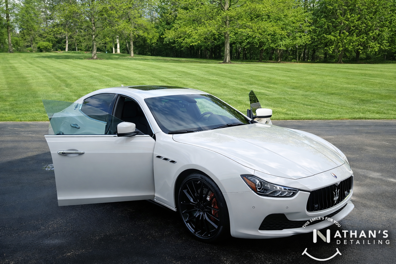 White maserati sedan door open detailed during mobile detailing in Aurora