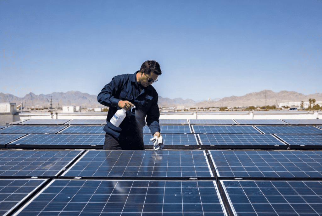 A solar technician implementing smart prevention to prevent dust from reducing solar panel efficiency in North Las Vegas.