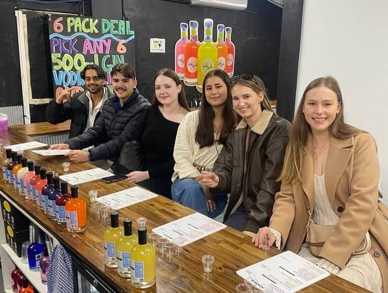 Group of friends enjoying wine tasting at Hunter Valley winery, showcasing a fun and social experience during a Hunter Valley Wine Tour.