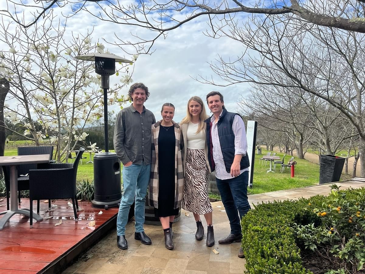 Enjoy a group of friends on a Hunter Valley wine tour, exploring scenic vineyards and tasting premium wines in a picturesque outdoor setting.