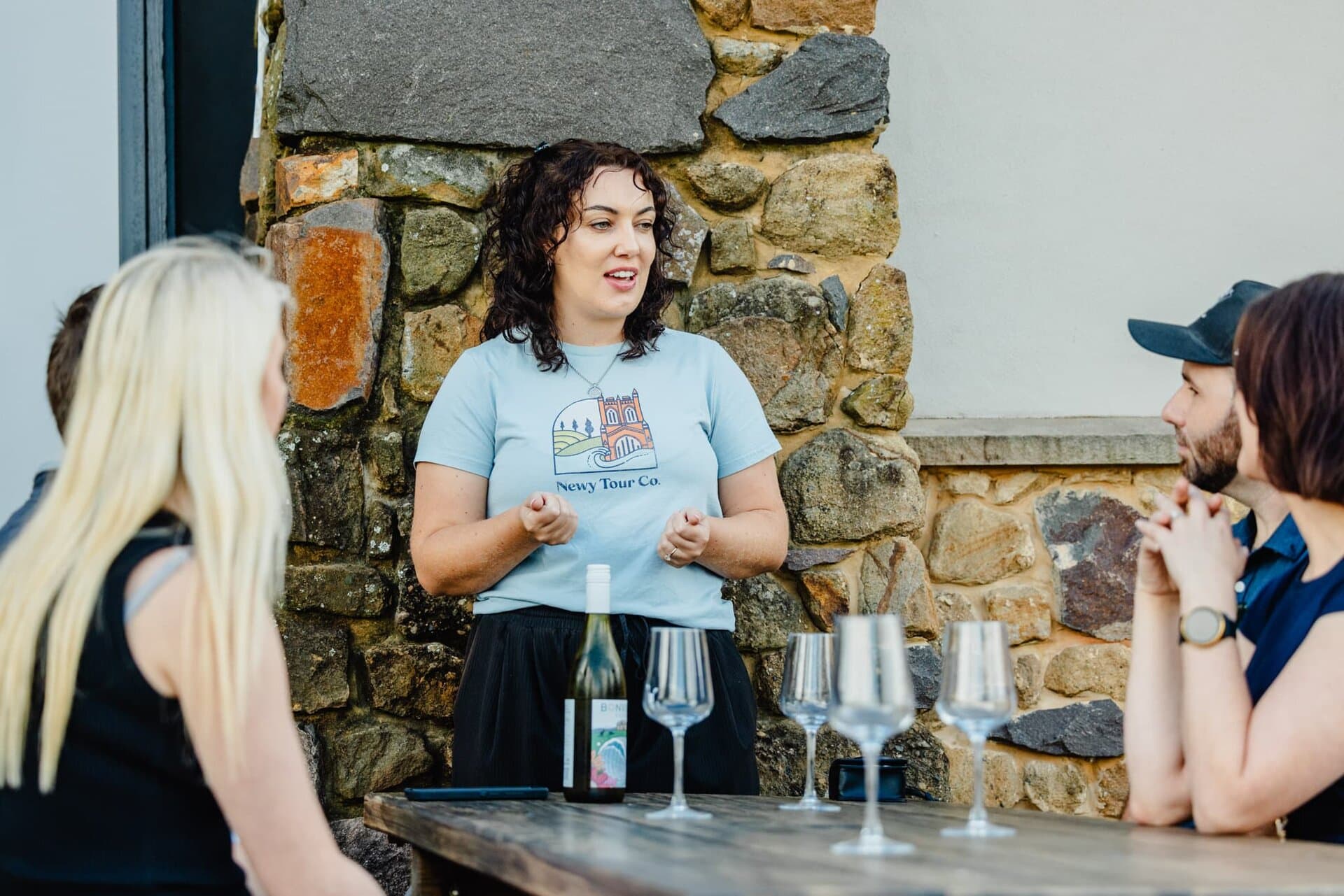 Guided tour host explaining local attractions to group at Newy Tour Co. event in Newcastle, Australia, providing expert tourism experiences.