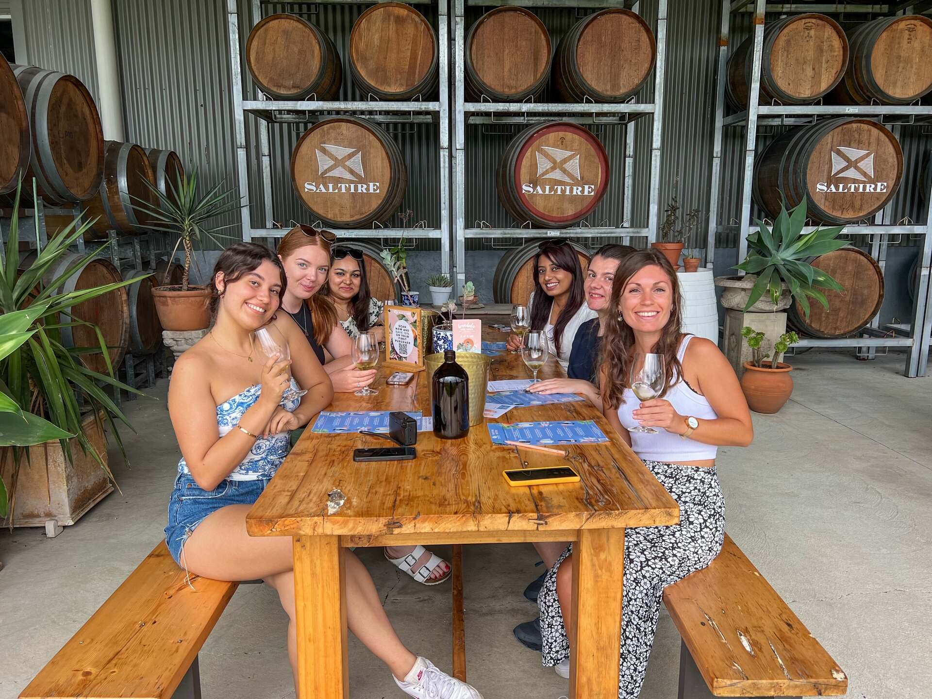 Enjoy a fun wine tasting experience with friends at a Hunter Valley winery, surrounded by scenic vineyards and wine barrels, perfect for a memorable day out.