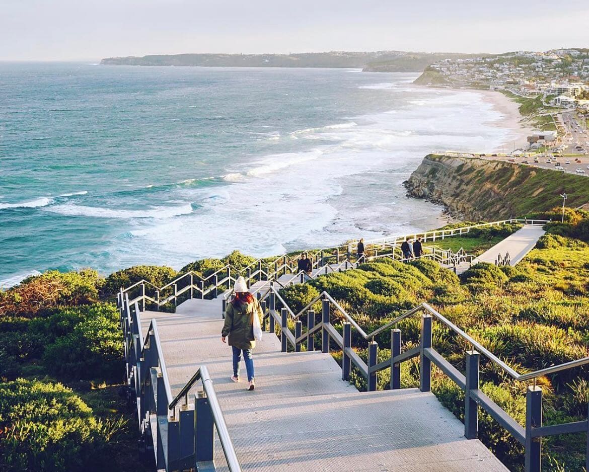 Scenic coastal cliff walk in Newcastle with ocean views and walking trail overlooking the sea and cityscape. Perfect for sightseeing and outdoor adventures.