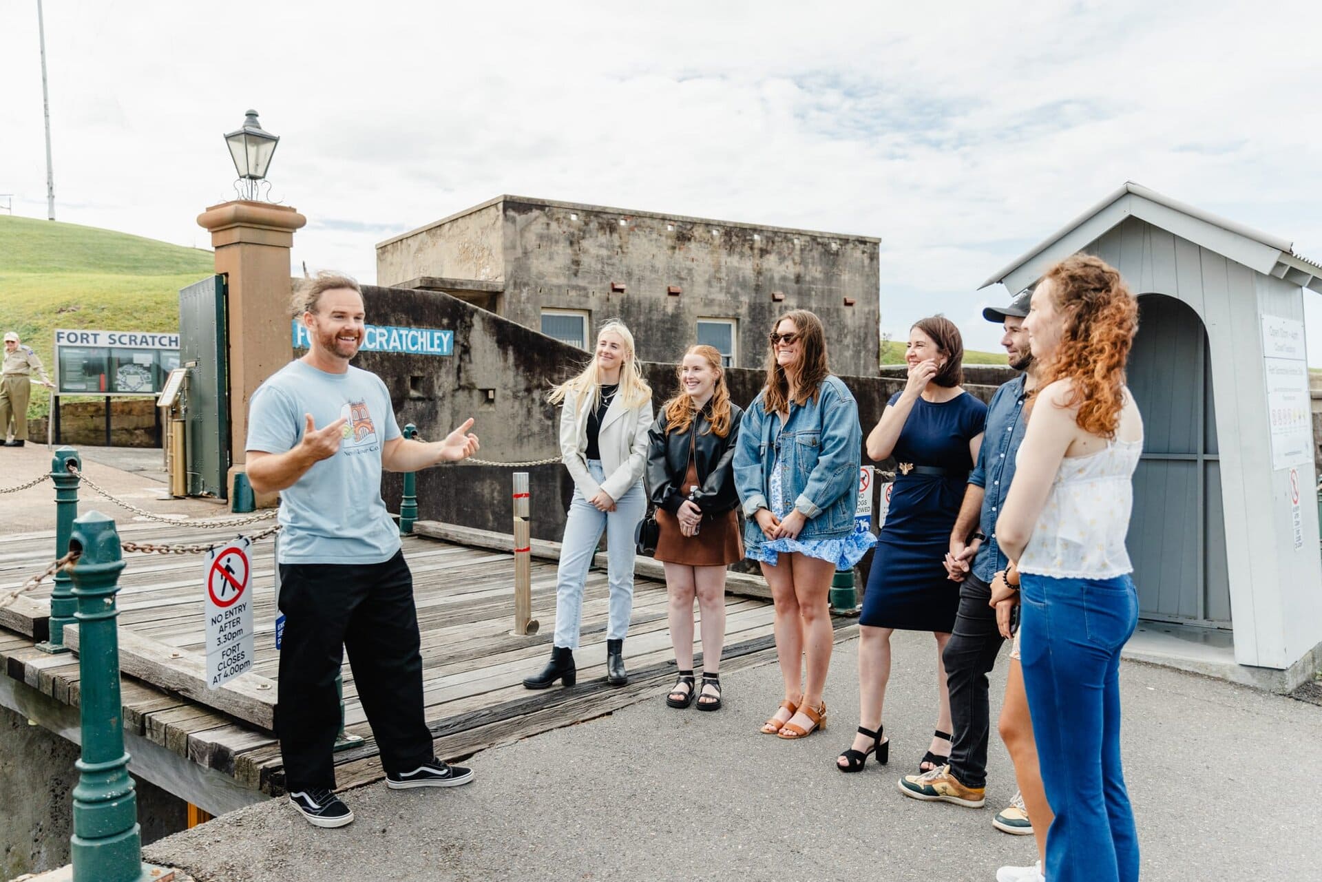 Excursion guide engaging a group of tourists at Fort Scratchley, historical Newcastle attraction, offering guided tours and sightseeing experiences in Newcastle, NSW.