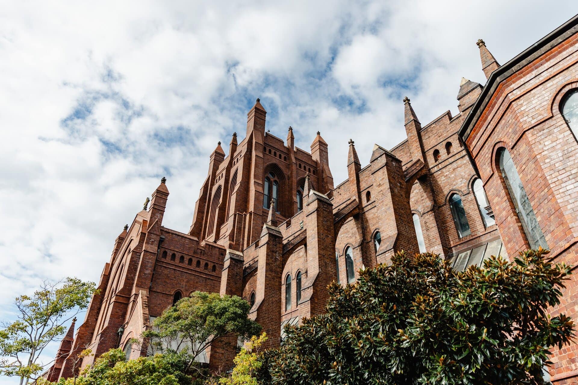 Historic red brick cathedral in New South Wales, perfect for sightseeing and cultural tours with Newy Tour Co.