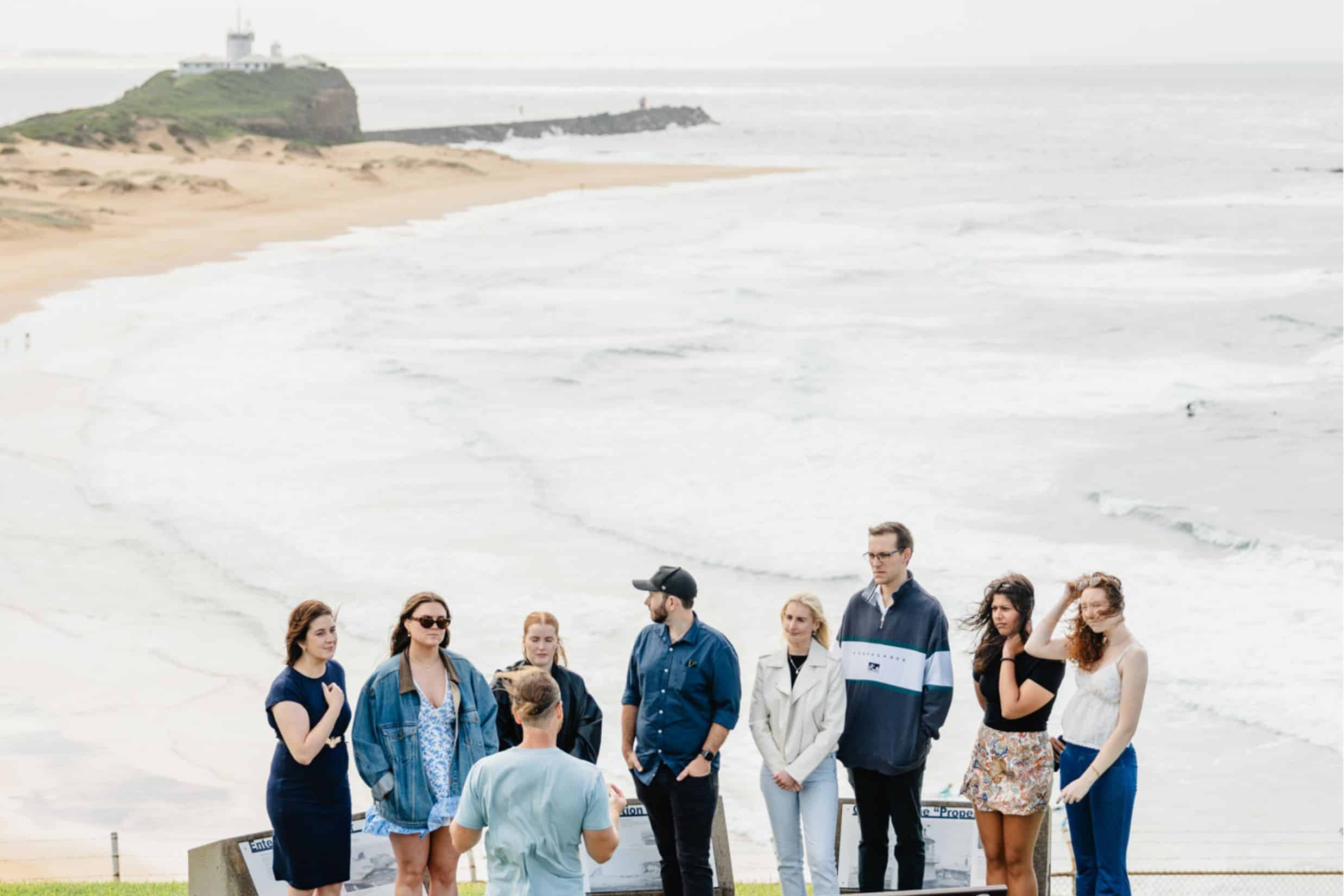 Vibrant group tour on Newcastle beach, showcasing scenic coastal views and guided sightseeing experiences with Newy Tour Co. for memorable adventures in New South Wales.