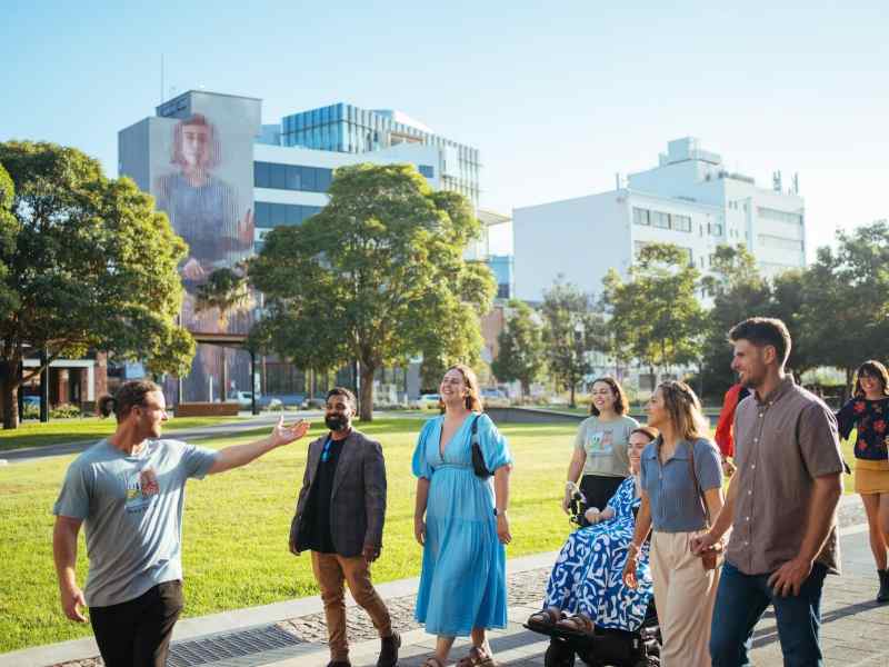 An engaging group tour in Newcastle exploring local cuisine and vibrant street art scenes. Participants enjoy tasting diverse foods while discovering colorful murals and urban art.