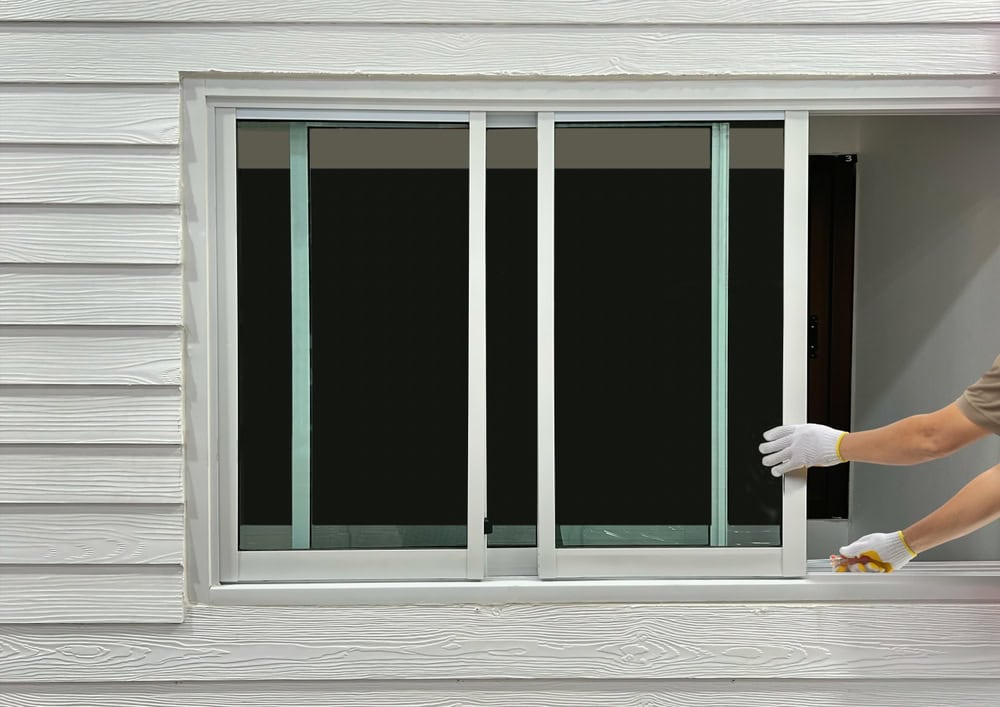 Installing new sliding windows for a modern home upgrade.