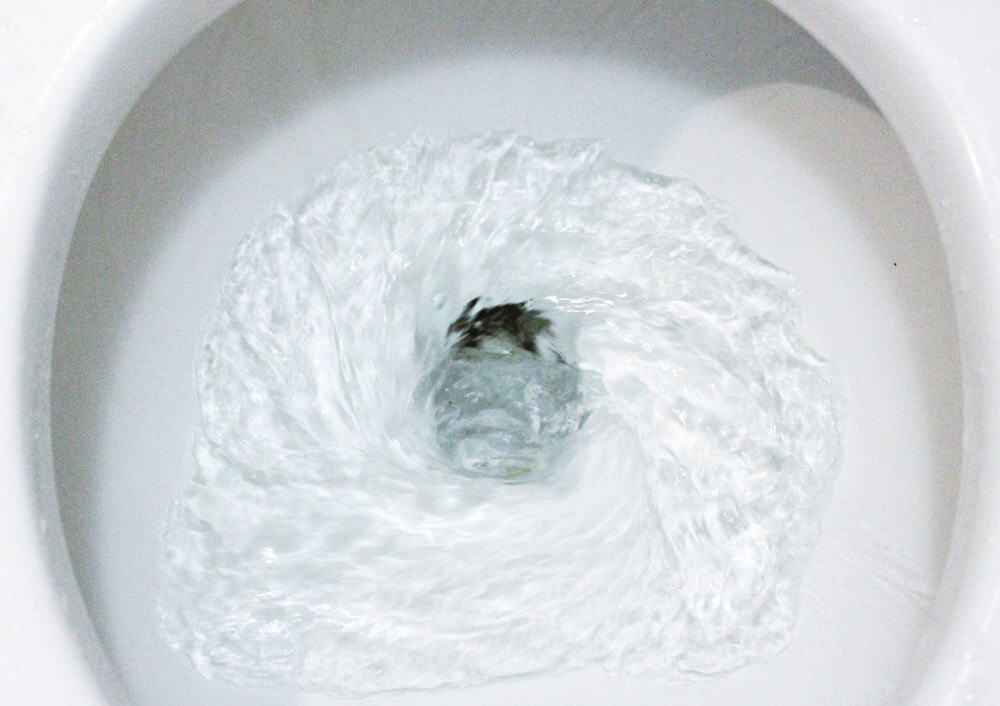 A swirling farewell—down the drain it goes!