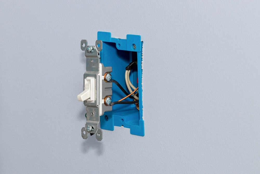 A light switch installation in progress.