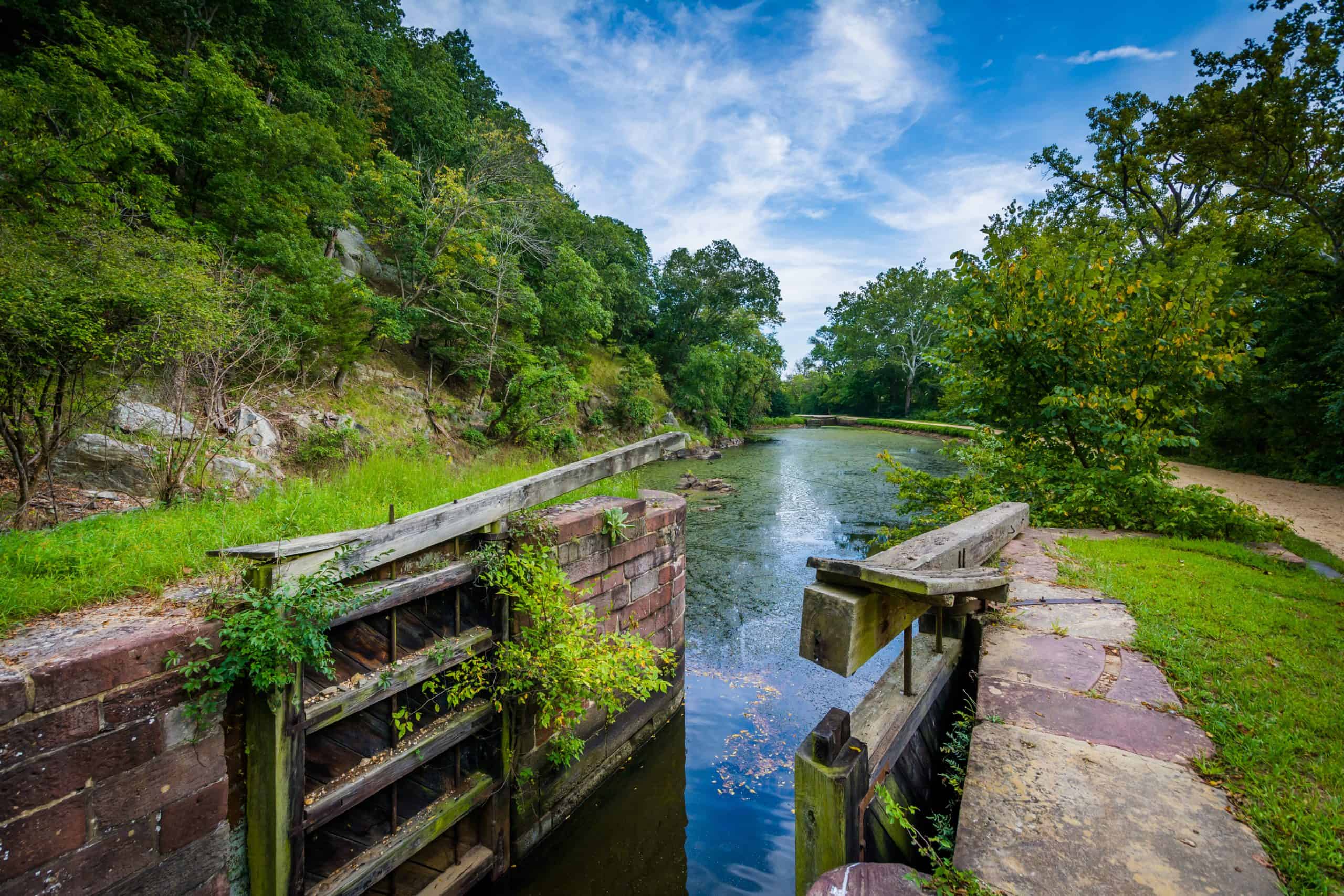 Historic lock along the scenic C&O Canal, surrounded by lush greenery and tranquil waters.