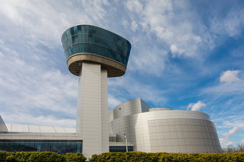 The National Air and Space Museum's Udvar-Hazy Center tower against a bright blue sky.