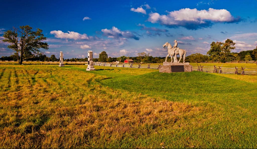 Historic serenity at Gettysburg, where monuments stand timeless under a vibrant sky.
