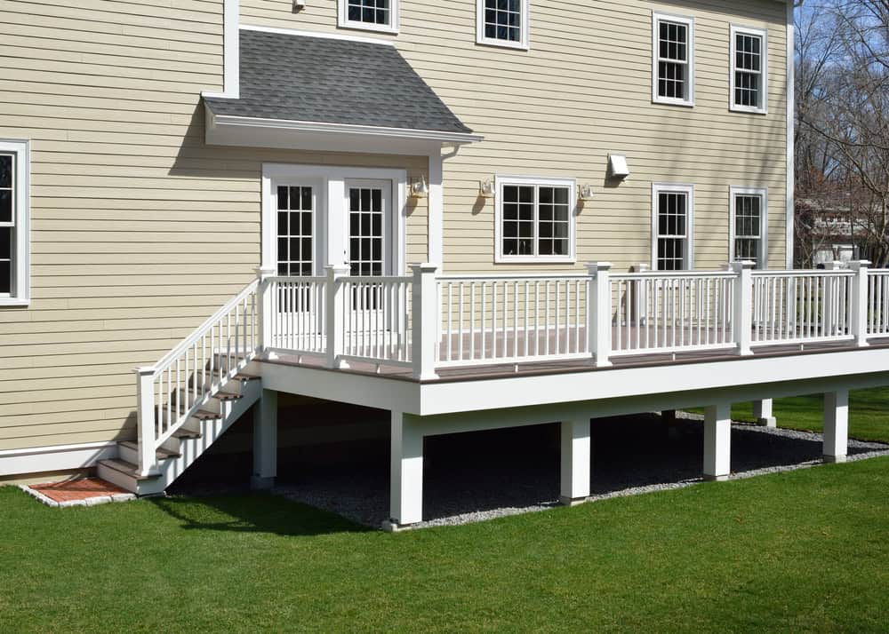 Residential wooden deck with railing and stairs being assessed during a professional deck inspection