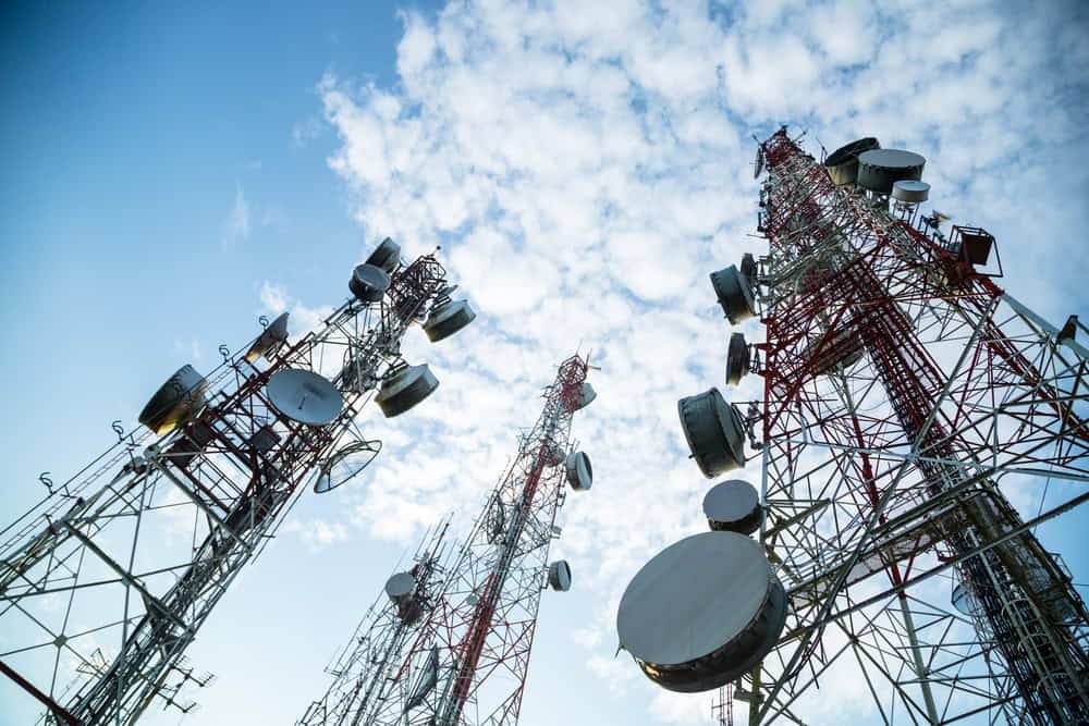 Towering above, these cellular towers connect the world with their intricate network of antennas and dishes.