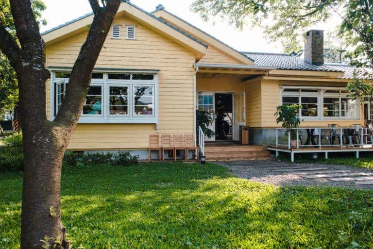 A single-story yellow house with a front porch