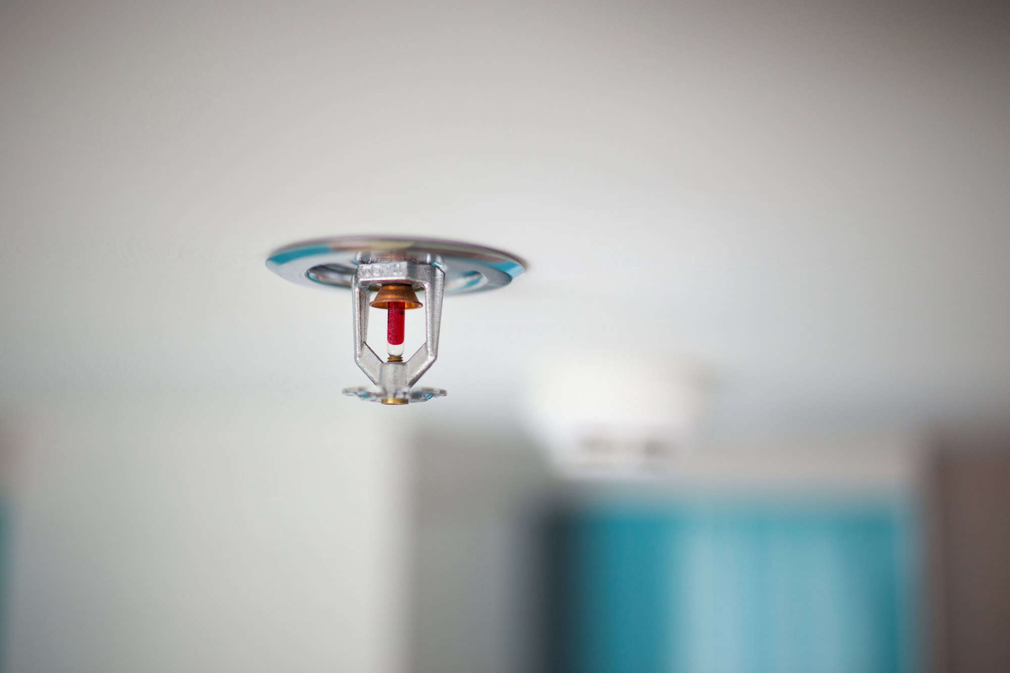Close-up of a ceiling-mounted fire sprinkler, ready to protect the room in case of emergency.
