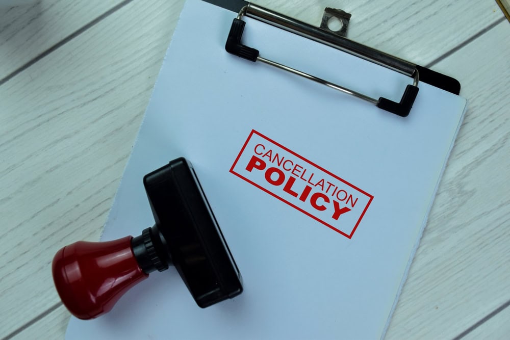 Cancellation policy document stamped and ready on a clipboard, highlighting important terms.