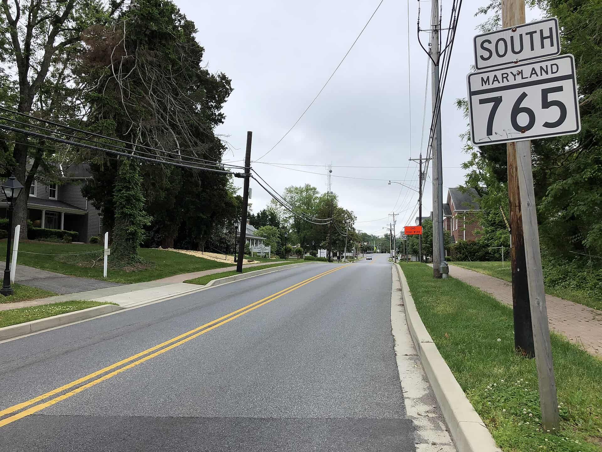 Main Street in Prince Frederick, Maryland, with houses and trees along the road
