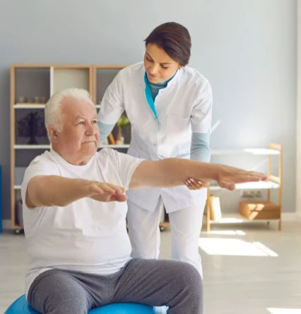 Elderly man doing physio with female nurse Photo of an elderly man doing physio with female nurse