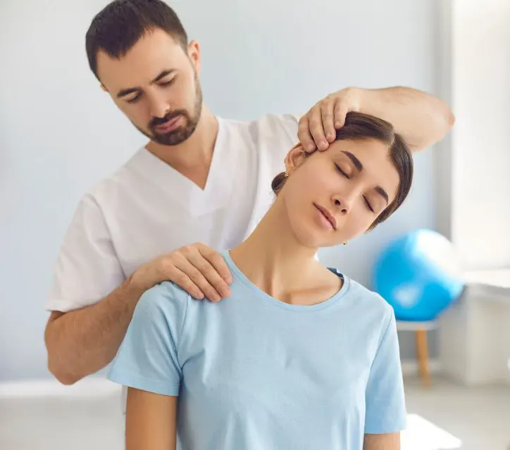 Physio with female patient Photo of a physiotherapist treating a female patient with a neck problem