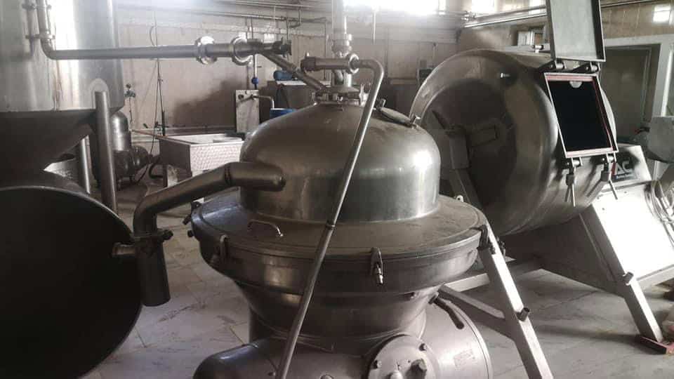 Stainless steel dairy processing equipment for milk pasteurization and storage.