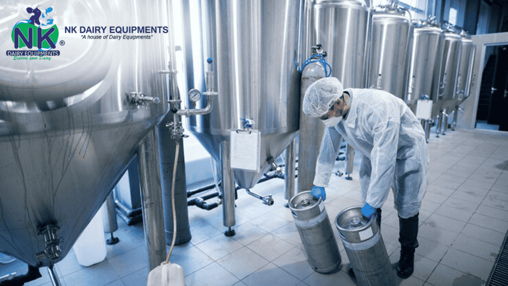 Brewery worker filling stainless steel containers in dairy processing plant.