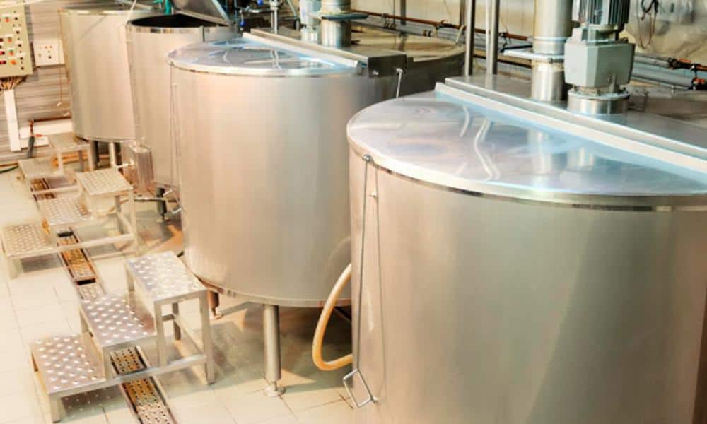 Stainless steel dairy storage tanks for milk processing and storage.