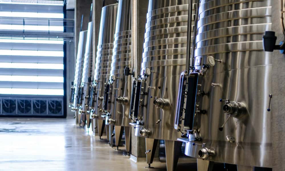 Stainless steel dairy fermentation tanks used in milk production plants.