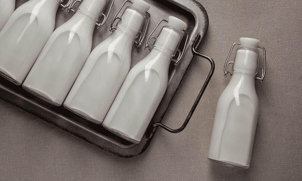 Steel milk bottles with swing tops for dairy processing and storage.
