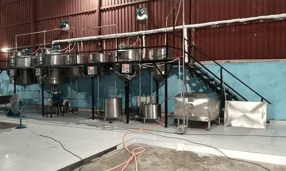 Stainless steel dairy processing equipment for milk production and packaging.