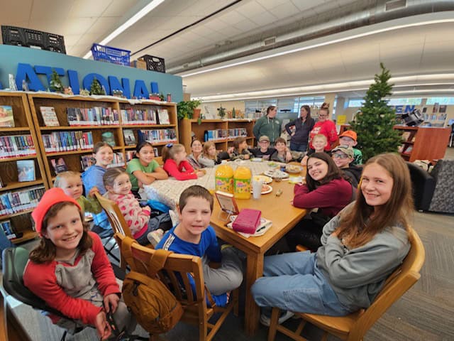 Kids and teens participating in a group activity at Northern Plains Public Library, highlighting community engagement and library programs for children.