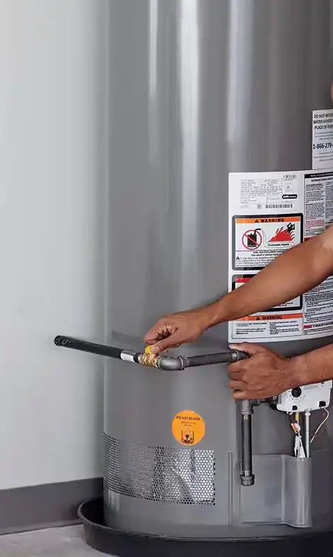 Plumber-Adjusting-Gas-Valve-On-Residential-Water-Heater-Tank
