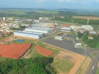 Infraestrutura industrial sustentável em área de expansão de negócio, com fábricas modernas, áreas de armazenamento e proximidade de vias de transporte, promovendo eficiência logística.