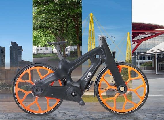 Bicicleta elétrica sustentável com rodas laranja, concebida para mobilidade urbana ecológica e inovação tecnológica em cidades inteligentes.