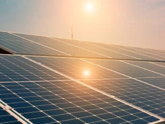 Painéis solares fotovoltaicos ao pôr do sol, promovendo energia limpa e sustentável para um futuro mais verde. Tecnologias de energias renováveis em foco na compensação ambiental.