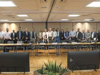 Profissionais reunidos em evento de sustentabilidade ambiental e gestão de recursos no ambiente corporativo.