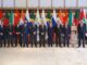 Países africanos e asiáticos em encontro internacional com bandeiras ao fundo, promovendo cooperação e relações diplomáticas.