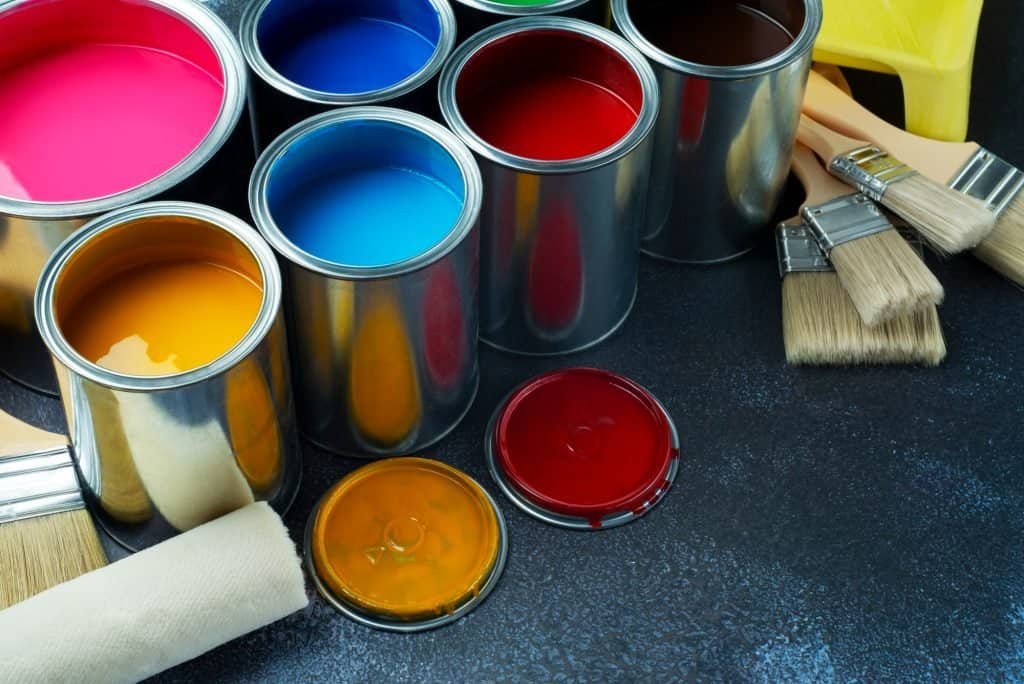 Assorted paint cans and brushes for interior painting projects.