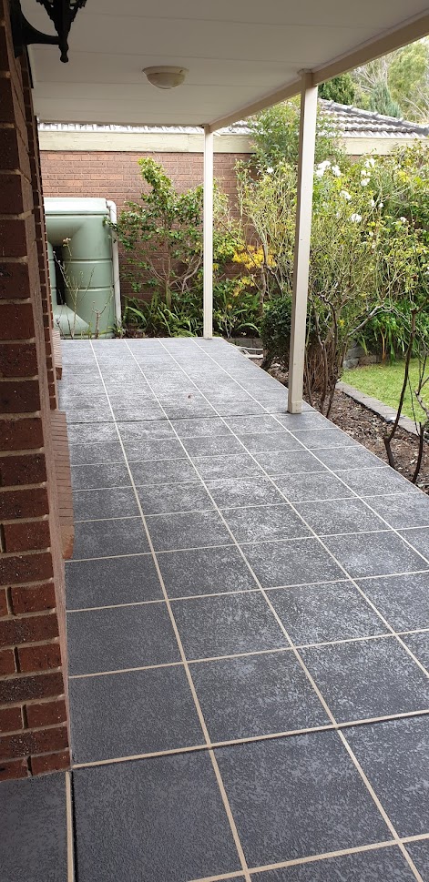 Tile pattern cut stone stencil concrete resurfacing on a Pakenham pathway beside a brick home.