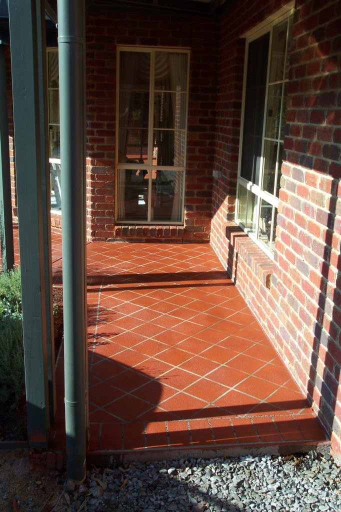Stenciled concrete resurfacing on red front verandah