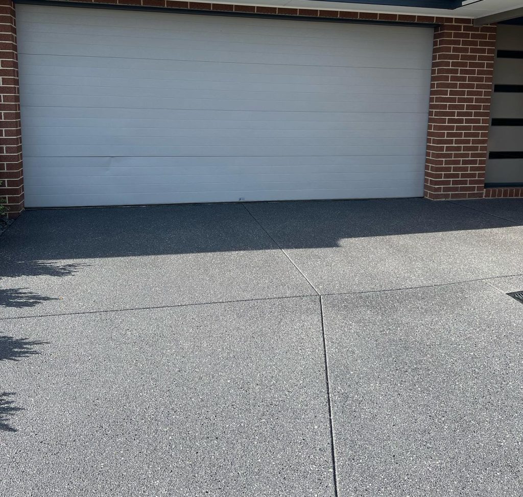 restored concrete driveway after grinding and sealing