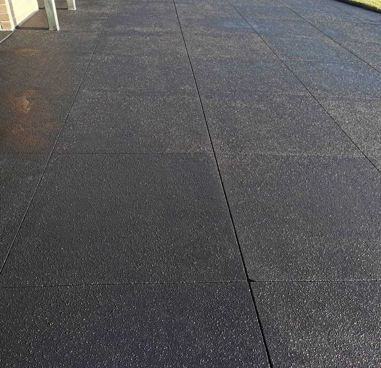Resurfaced concrete driveway with spray-on paving