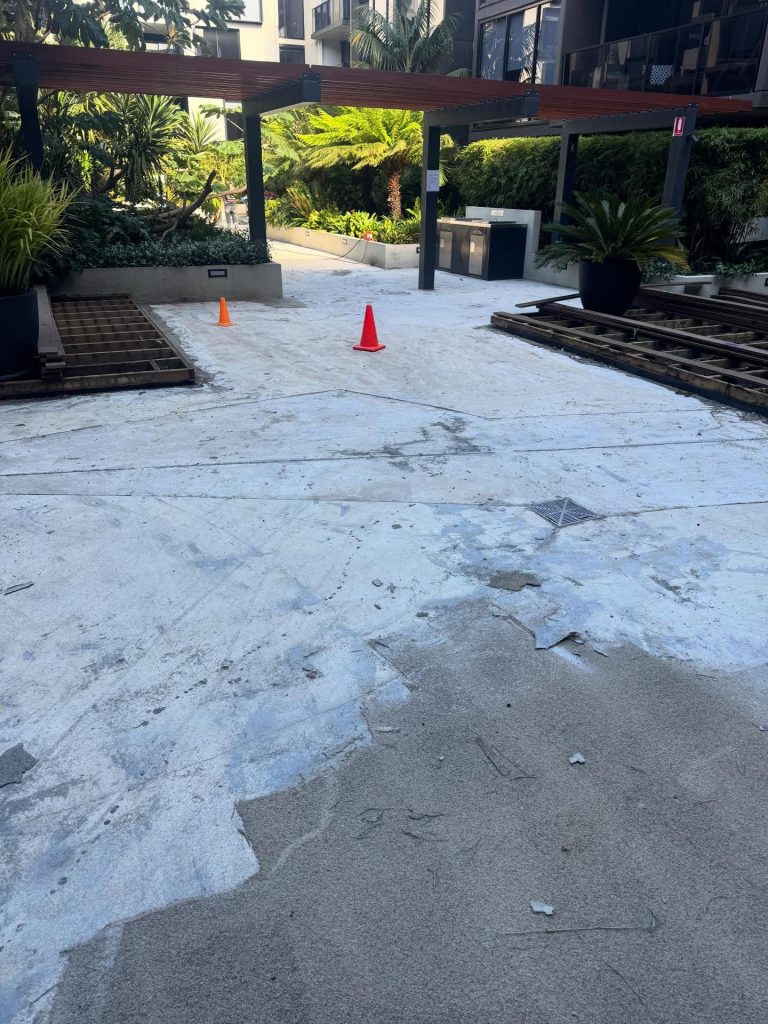 Commercial concrete resurfacing Melbourne before restoration exposed aggregate surface