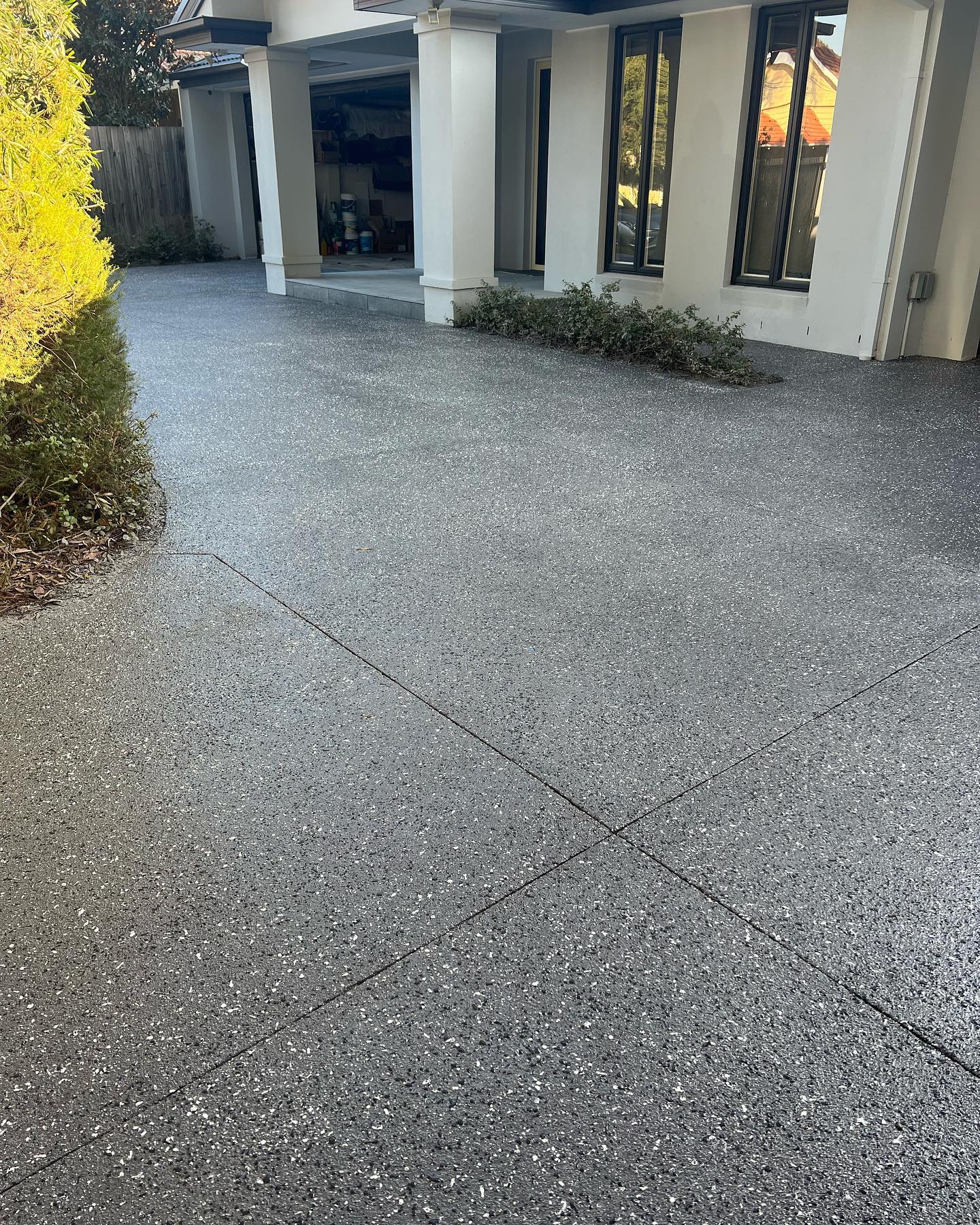 Concrete driveway restoration with spray-on finish
