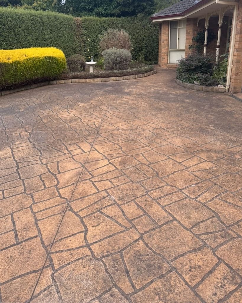 Worn stencil concrete driveway before resurfacing in Mount Evelyn