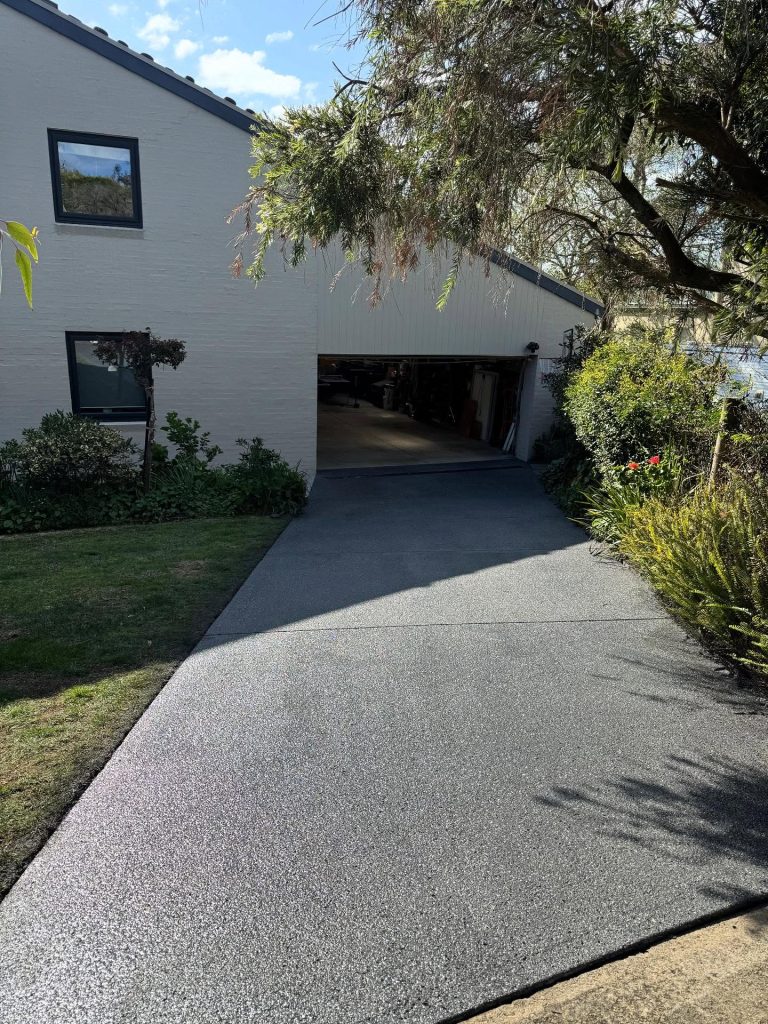 Non-slip concrete resurfacing completed on sloped driveway in Mount Martha with textured exposed aggregate finish