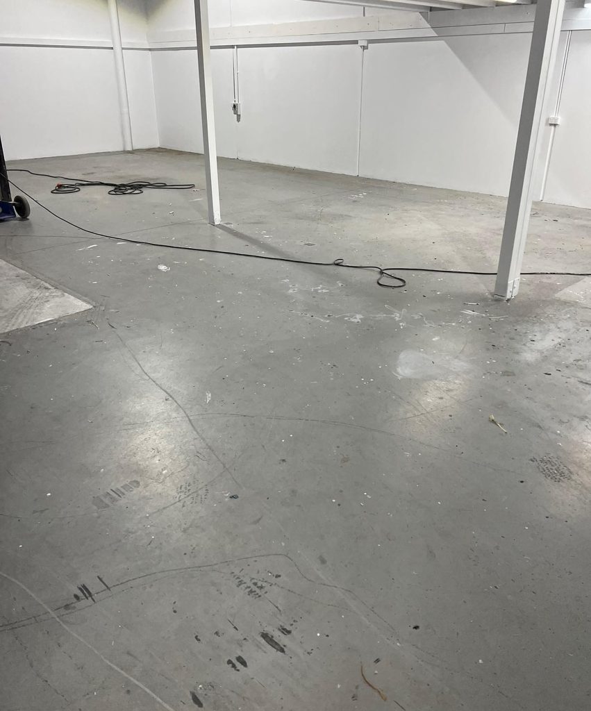 Before epoxy flake coating in Seaford commercial workspace